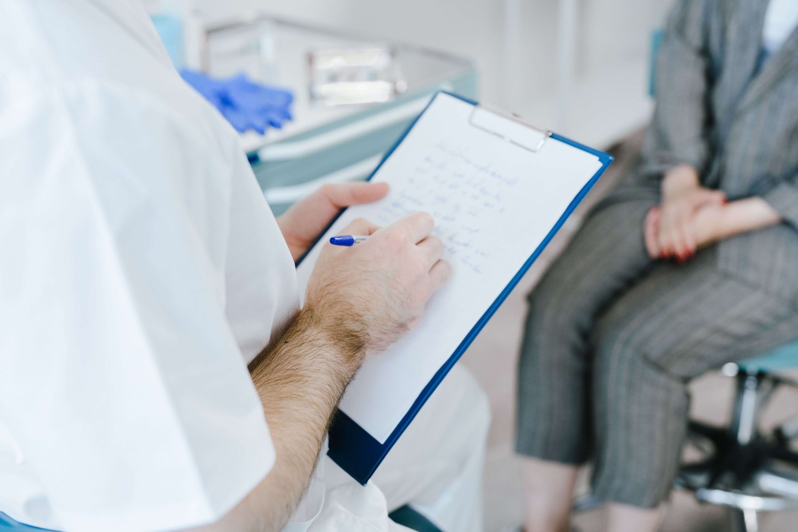 Audiologist testing patient ears using precision probe